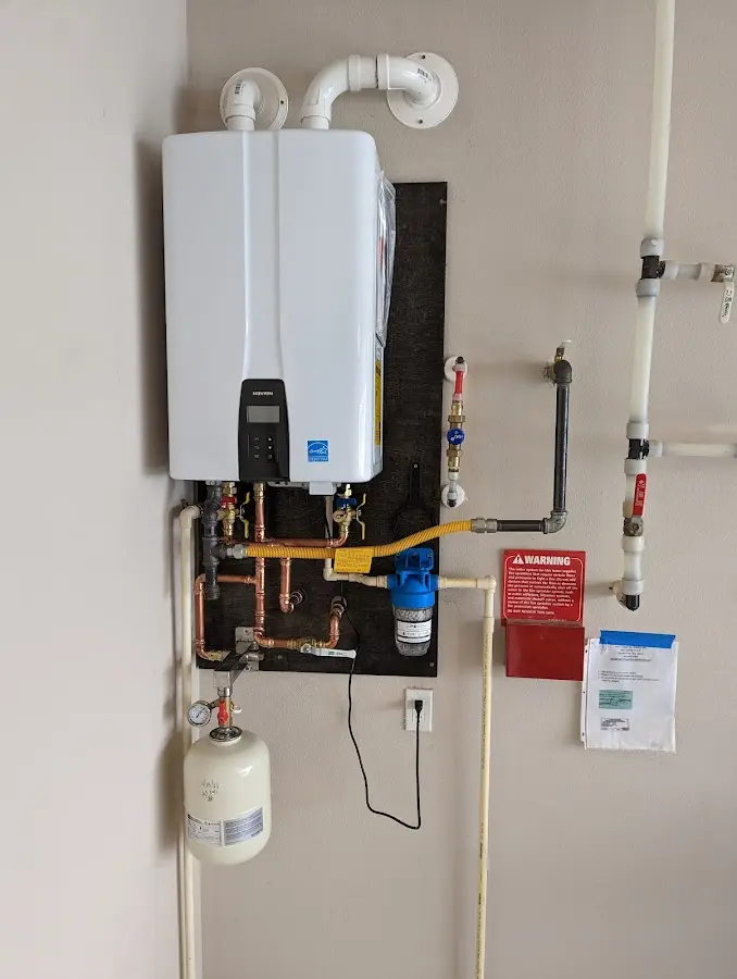 Professional plumber installing copper piping in a Jenks home